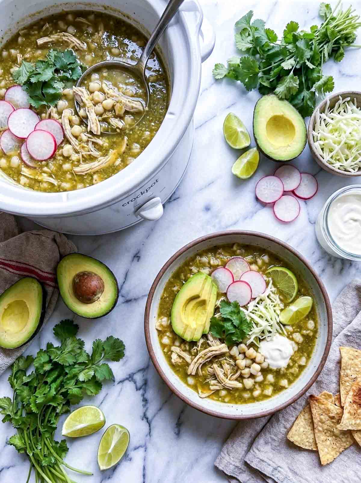 A bowl of chicken pozole verde made with hominy in a crockpot.
