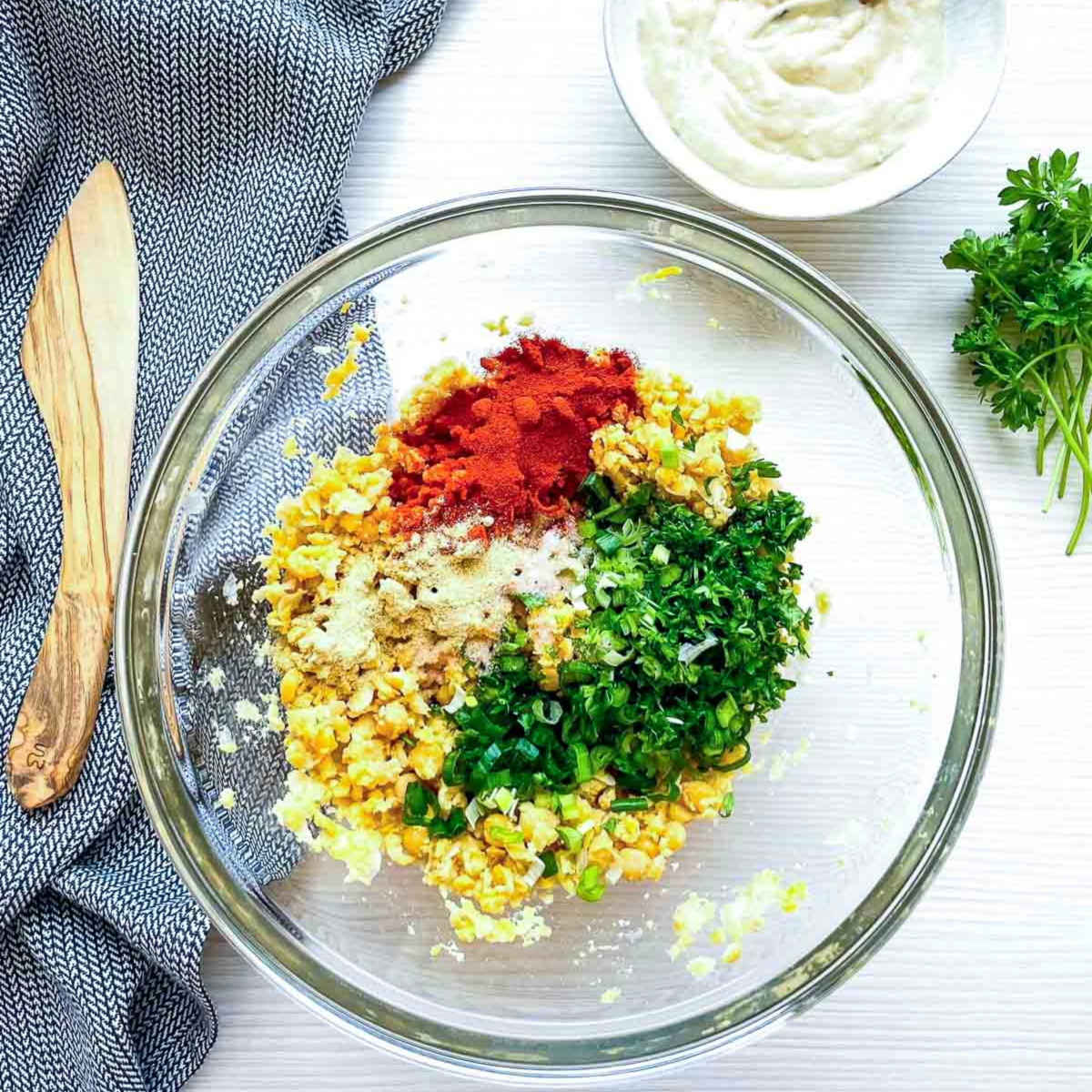 Falafel mixture with spices and herbs in bowl
