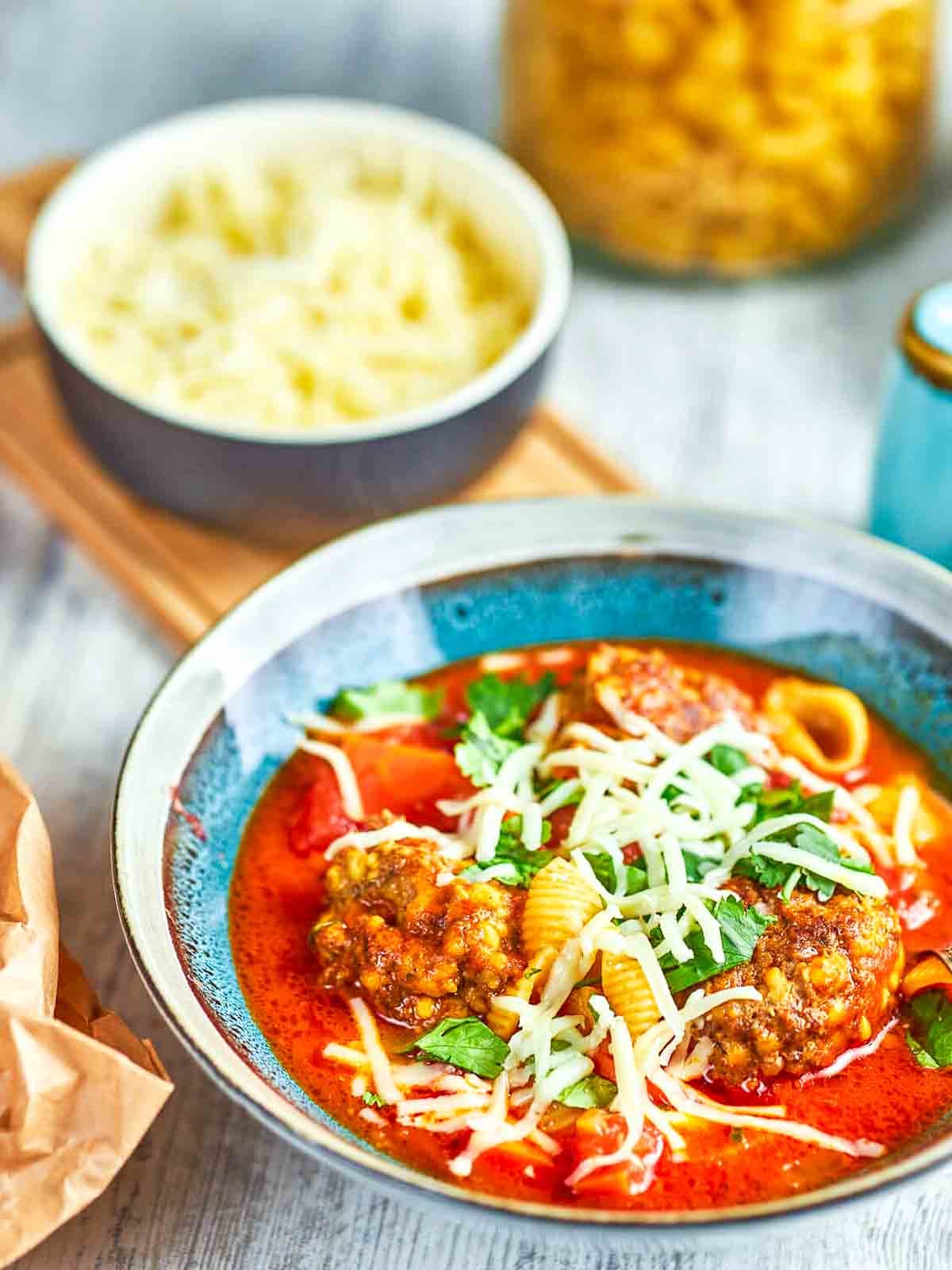 Italian meatball soup with pasta, herbs, and cheese