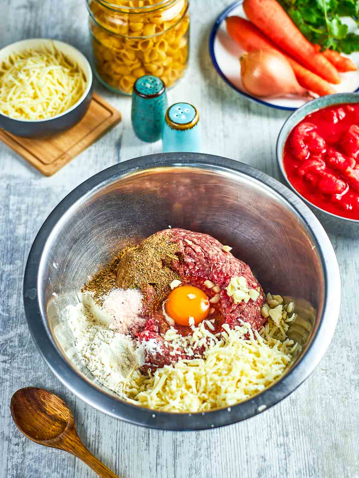 Ground meat, egg, cheese, and spices in bowl